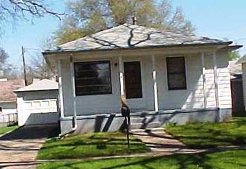 Fremont apartment for rent - A small white house with a black door and a window.