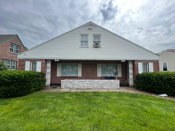 Fremont apartment for rent - A house with a red brick wall and a white porch.
