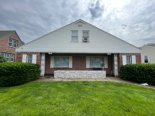 Fremont apartment for rent - A house with a red brick wall and a white porch.