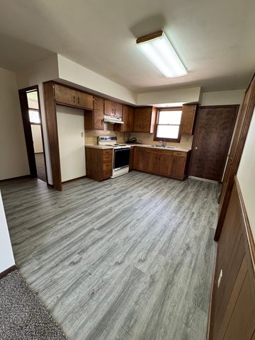 Fremont apartment for rent - A kitchen with wooden cabinets and a grey floor.