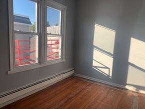 Irvington apartment for rent - an empty room with three windows and a wooden floor