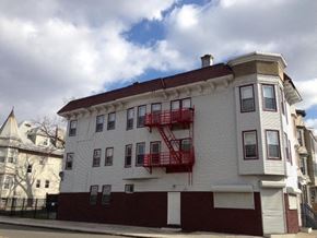 Irvington apartment for rent - a white building with a red fire