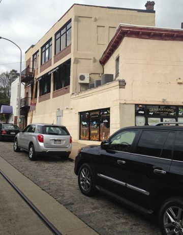 Philadelphia apartment for rent - a city street with cars parked in front of a building