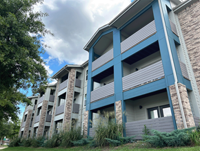 Fayetteville apartment for rent - an apartment building with blue balconies on a cloudy day