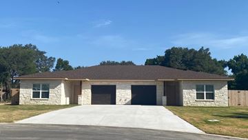 Salado apartment for rent - A two-car garage with a stone exterior.