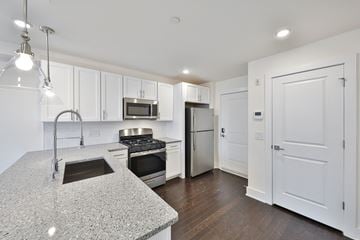 Philadelphia apartment for rent - a kitchen with white cabinets and stainless steel appliances