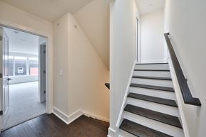 Philadelphia apartment for rent - an empty hallway with a staircase and a door to a living room