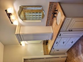 Chandler house for rent - A bathroom with a brown counter top and a white sink.