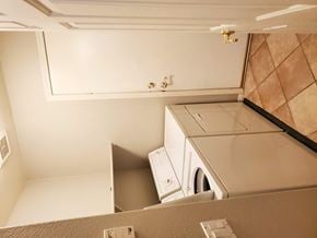 Chandler house for rent - A white washing machine is installed in a small laundry room.