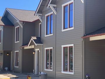 Cloverdale apartment for rent - a row of houses with gray siding and blue windows