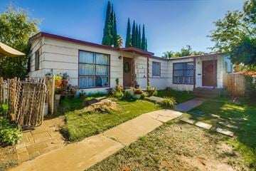 Escondido apartment for rent - the front of a house with a yard and a sidewalk