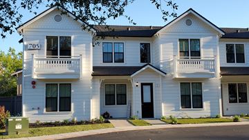 Cloverdale apartment for rent - A white two story house with the number 705 on the front.