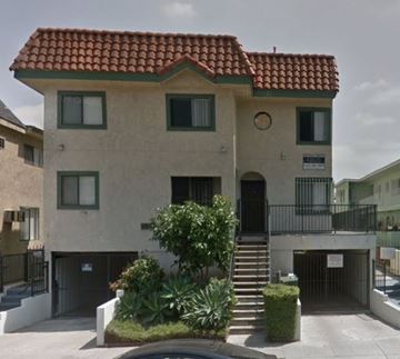 Los Angeles apartment for rent - A two-story building with a red tile roof and a balcony on the second floor.
