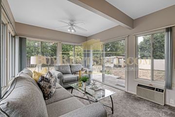 Crystal house for rent - A living room with a grey couch and a glass table.