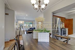 Crystal house for rent - A dining room with a wooden table and chairs.