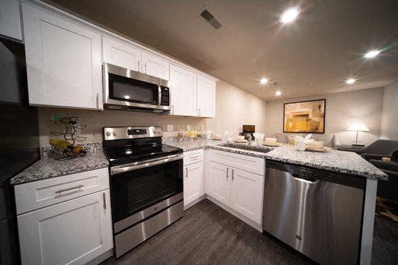 Sterling Heights apartment for rent - a kitchen with stainless steel appliances and white cabinets