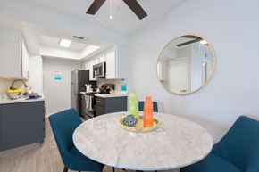 Phoenix apartment for rent - A kitchen with a table and chairs in the foreground.