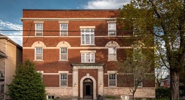 Ottawa apartment for rent - a red brick building with a blue sky in the background