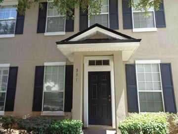 Orange Park house for rent - A house with a black front door and windows with black shutters.