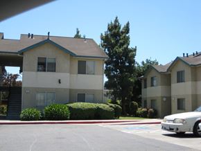 Hayward apartment for rent - an apartment building in a parking lot with a car
