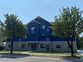 Saint Paul apartment for rent - a blue and white building with trees in front of it