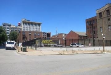St. Louis apartment for rent - A city street with a white van and a black truck.