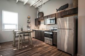 Jasper apartment for rent - a kitchen with stainless steel appliances and a wooden table