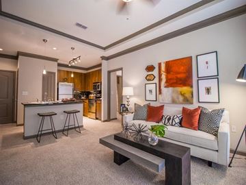 Dunwoody apartment for rent - A living room with a white couch and a bar area.