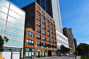 Chicago apartment for rent - a tall brick building on the corner of a city street
