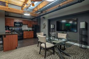 Chicago apartment for rent - A modern kitchen with a glass table and chairs.