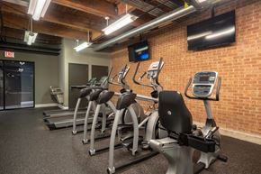 Chicago apartment for rent - A gym with treadmills and a brick wall.
