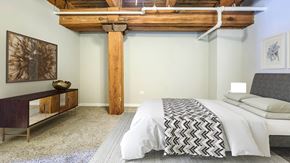 Chicago apartment for rent - a bedroom with a bed and a wooden beam