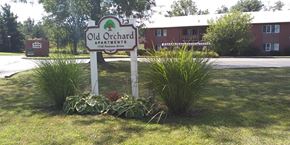 Geneva apartment for rent - a sign for old orchard apartments in front of some plants