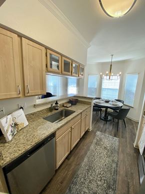 Houston apartment for rent - an open kitchen and dining room with a table and chairs