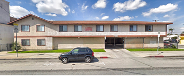 Huntington Park apartment for rent - a small car parked in front of a building