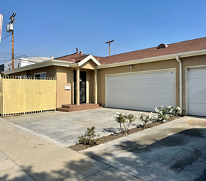 Maywood apartment for rent - A house with a brown roof and a white garage door.