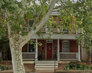Richmond apartment for rent - A red door is on the front of a brick house.