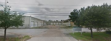 Houston apartment for rent - a large building with trees and a sign in front of it