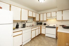 Wyoming apartment for rent - a large kitchen with white appliances and white cabinets