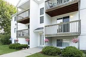 Wyoming apartment for rent - a white house with two balconies and a sidewalk