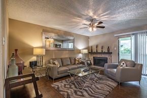 San Antonio apartment for rent - A living room with a fireplace and a couch.