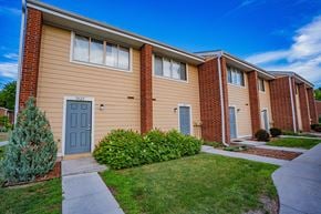 Minnetonka townhouse for rent - a sidewalk in front of a building with a blue door