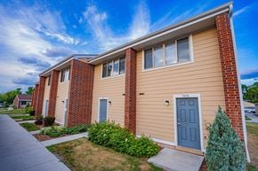 Minnetonka townhouse for rent - a building with a blue door and a sidewalk in front of it