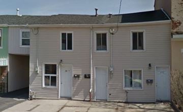 Hamilton apartment for rent - A two-story house with a garage on the ground floor.