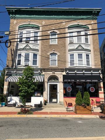 Montclair apartment for rent - A building with a striped awning and a sign that says Urban Chicken.