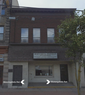 Glassport apartment for rent - the front of a brick building with two arrows pointing to different directions