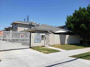 Long Beach apartment for rent - a house with a white fence and a yard in front of it