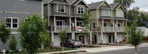 Beaverton apartment for rent - A row of houses with a car parked in front of the first one.