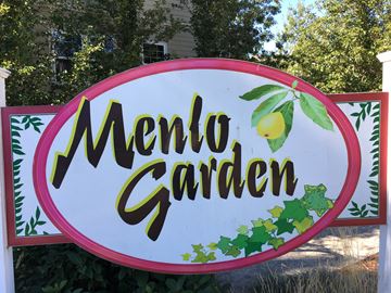 Beaverton apartment for rent - A sign that says Menlo Garden with a lemon on it.