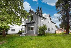 Tacoma apartment for rent - a gray house with a yard in front of it